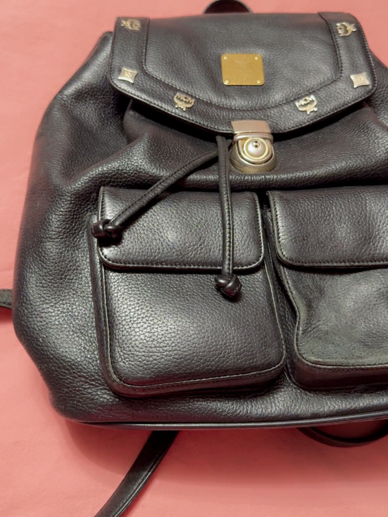 Mcm Black Pebbled Leather Drawstring Backpack With Gold Accents